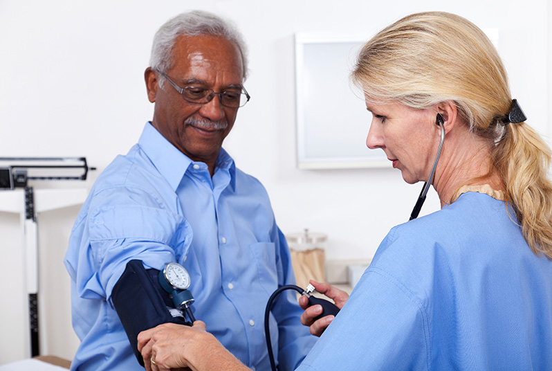 Provider taking a patient's blood pressure