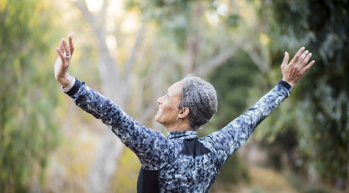 Woman outside stretching arms