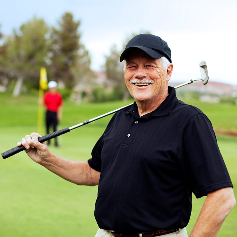 Senior man holding a golf club