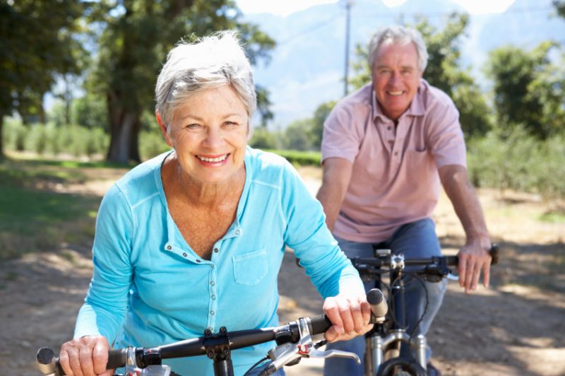 Senior man and woman riding bikes